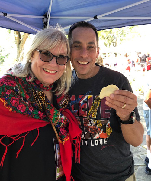 Connie Adams helping Dave Gilbert make a pierogi in the Polish Garden